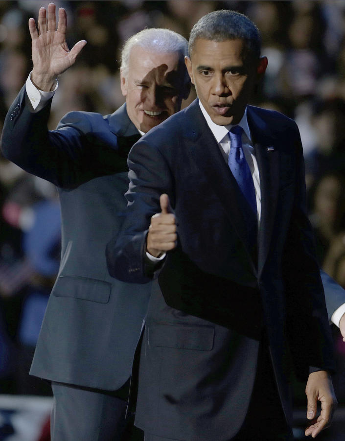 President Barack Obama flashes a thumbs up as he leaves the stage with Vice President Joe Biden at his election night party Wednesday, Nov. 7, 2012, in Chicago. President Obama defeated Republican challenger former Massachusetts Gov. Mitt Romney. (AP Photo/M. Spencer Green)