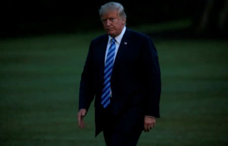 U.S. President Donald Trump walks across the South Lawn after arriving in Marine One from a recent trip to New York at the White House in Washington, U.S., August 13, 2018. REUTERS/Leah Millis