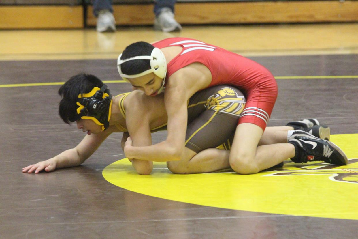 Holland wrestler gets set to take on a Zeeland East wrestler (photo from 2020/21 season)