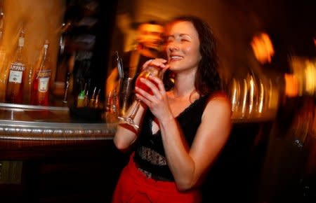 FILE PHOTO: A woman drinks a spritz cocktail with Aperol at the