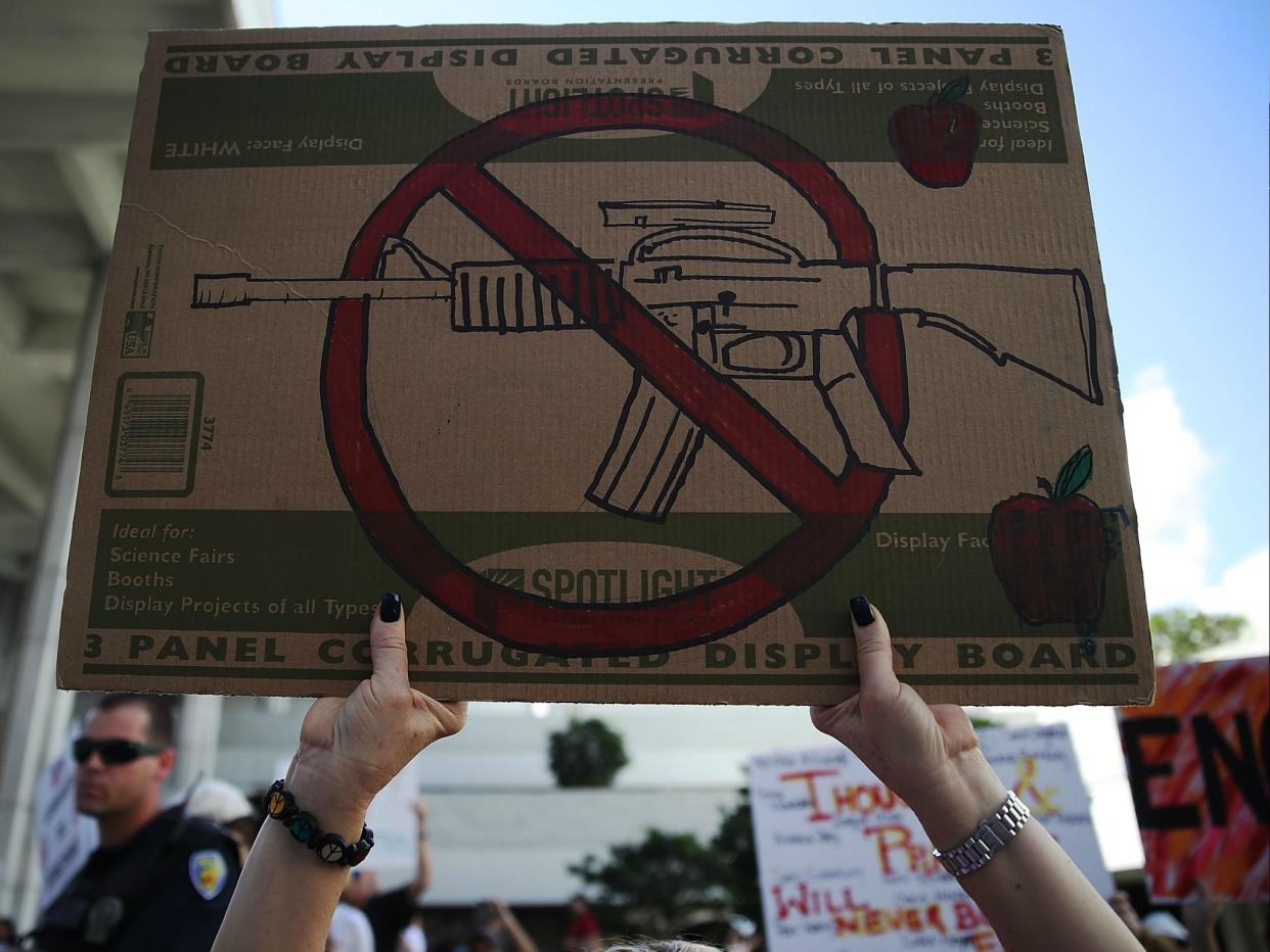 People join together after a school shooting that killed 17 to protest against guns on 17 February 2018 in Fort Lauderdale, Florida: Joe Raedle/Getty Images