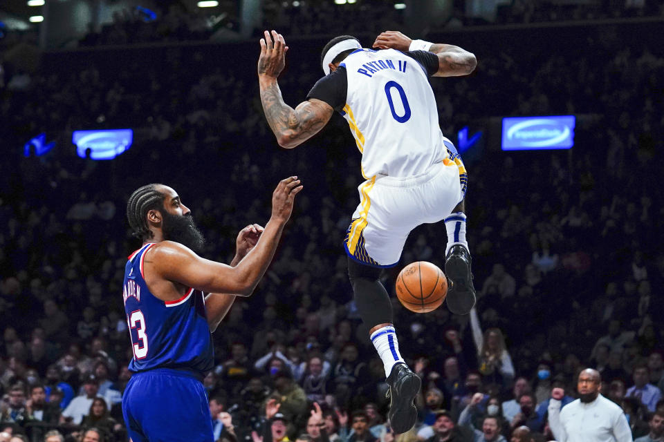 Brooklyn Nets' James Harden (13) reacts as Golden State Warriors' Gary Payton II (0) dunks the ball in front of him during the first half of an NBA basketball game Tuesday, Nov. 16, 2021 in New York. (AP Photo/Frank Franklin II)