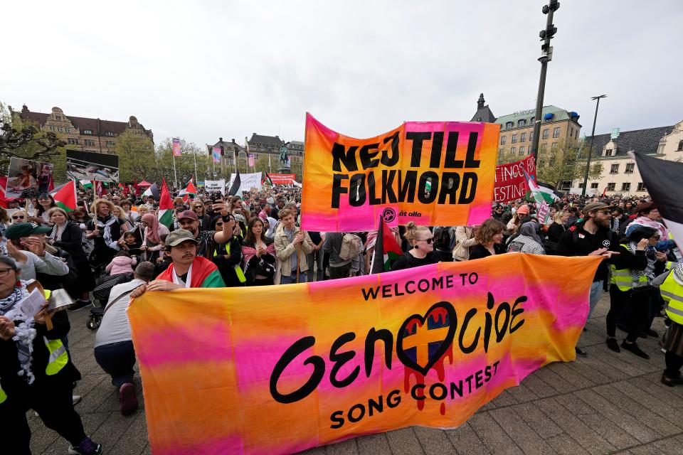 Protesters hold a banner with the words in Swedish 