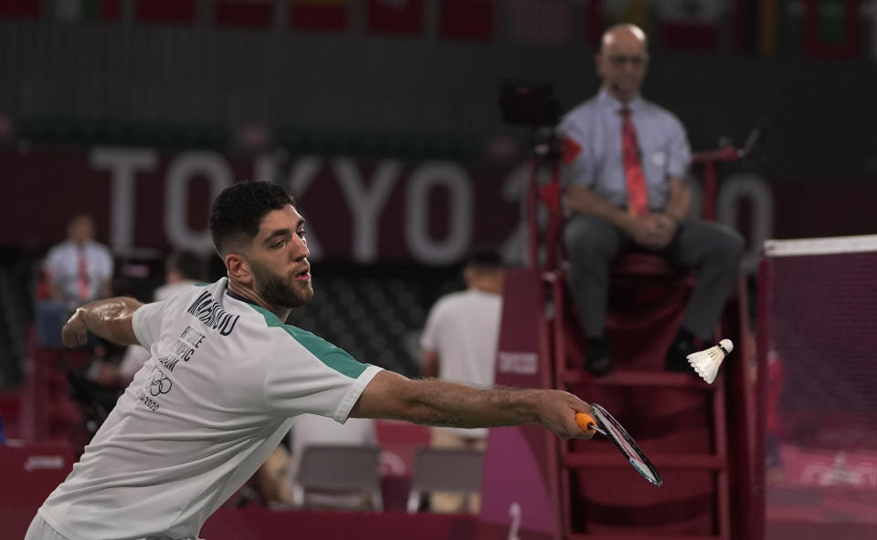 Refugee Olympic team's Aram Mahmoud plays against Kean Yew Loh of Singapore during men's singles Badminton match at the 2020 Summer Olympics, Monday, July 26, 2021, in Tokyo, Japan. (AP Photo/Markus Schreiber)