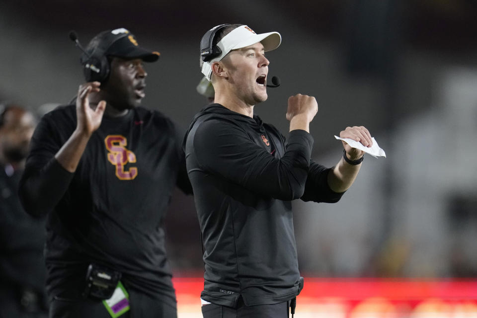 Southern California head coach Lincoln Riley signals from the sideline during the second half of an NCAA college football game against Arizona, Saturday, Oct. 7, 2023, in Los Angeles. (AP Photo/Marcio Jose Sanchez)