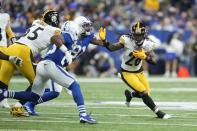 Pittsburgh Steelers' Anthony McFarland Jr. runs against Indianapolis Colts' Yannick Ngakoue (91) during the first half of an NFL football game, Monday, Nov. 28, 2022, in Indianapolis. (AP Photo/Michael Conroy)