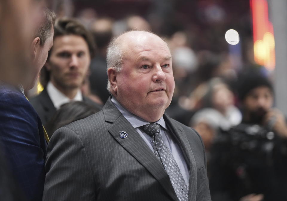 Vancouver Canucks coach Bruce Boudreau stands behind the bench before the team's NHL hockey game against the Edmonton Oilers on Saturday, Jan. 21, 2023, in Vancouver, British Columbia. (Darryl Dyck/The Canadian Press via AP)