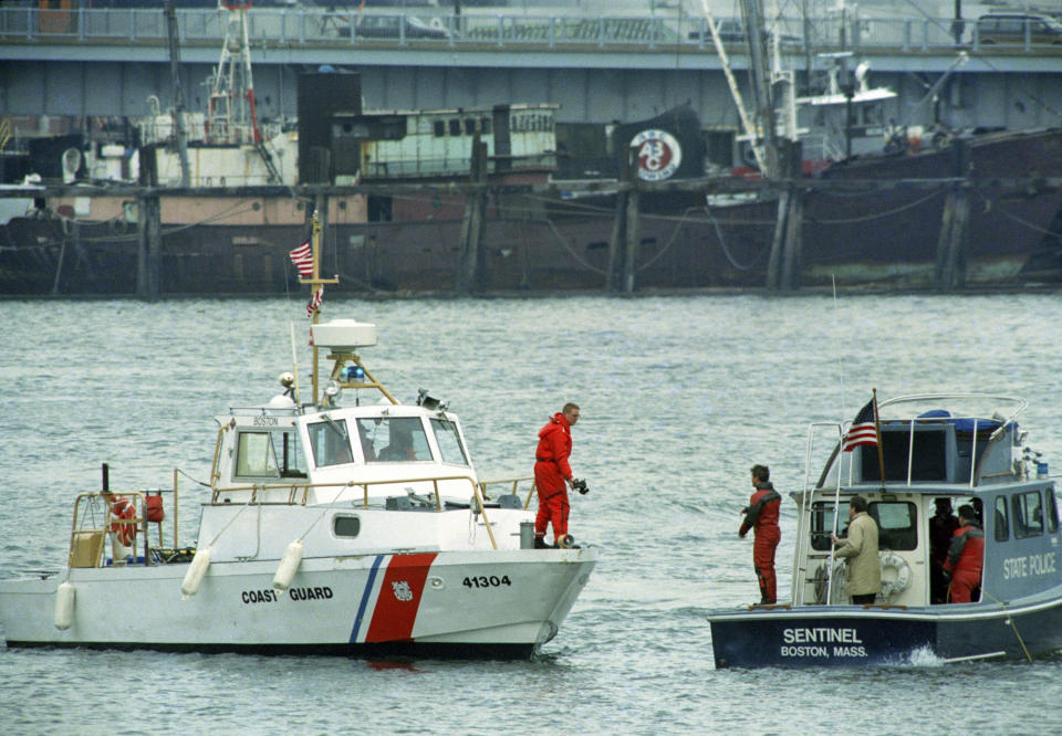 FILE - Boston Police and Coast Guard boats search the water for the body of Charles Stuart, who police believed jumped from the Tobin Bridge in Boston, Jan. 4, 1990. On Wednesday, Dec. 20, 2023, Boston Mayor Michelle Wu plans to formally apologize on behalf of the city to Alan Swanson and Willie Bennett for their wrongful arrests following the 1989 death of Carol Stuart, whose husband, Charles Stuart, had orchestrated her killing. Stuart blamed his wife’s killing — and his own shooting during what he portrayed as an attempted carjacking — on an unidentified Black gunman, leading to a crackdown by police in one of the city’s traditionally Black neighborhoods in pursuit of a phantom assailant. (AP Photo/Elise Amendola, File)