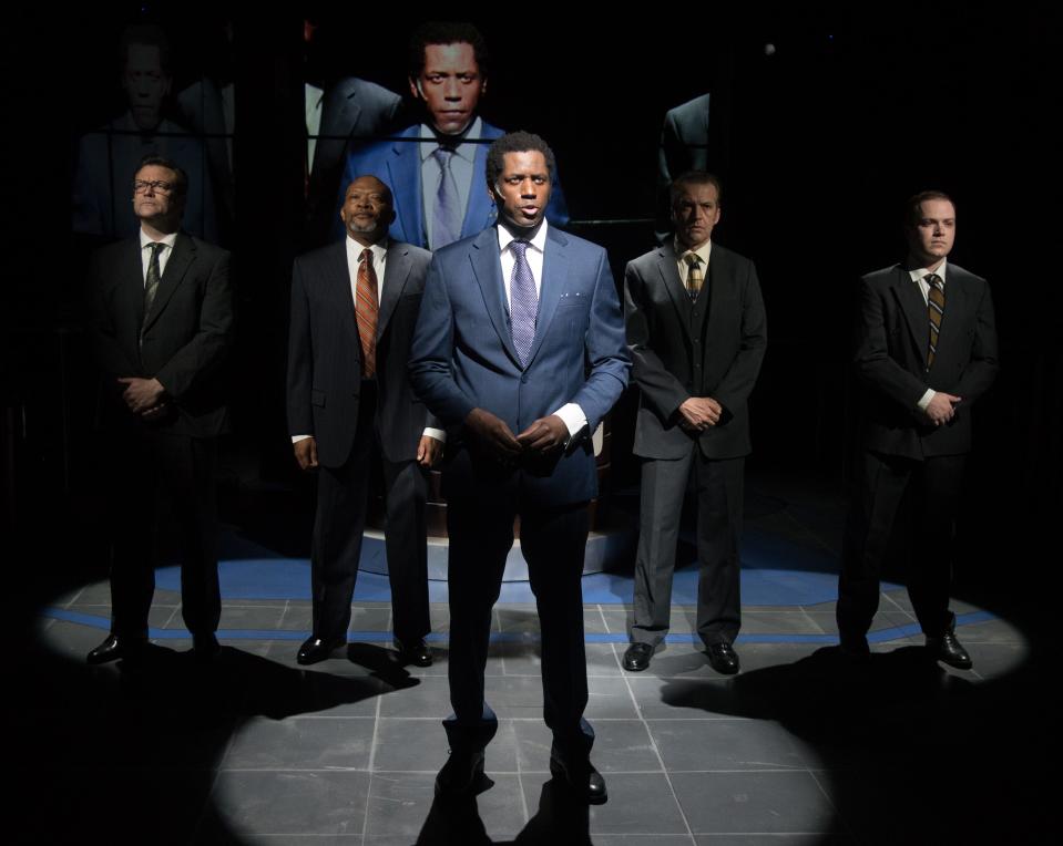 Sean Phillips, center, plays a hard-charging corporate executive in Florida Studio Theatre’s production of “Network.”