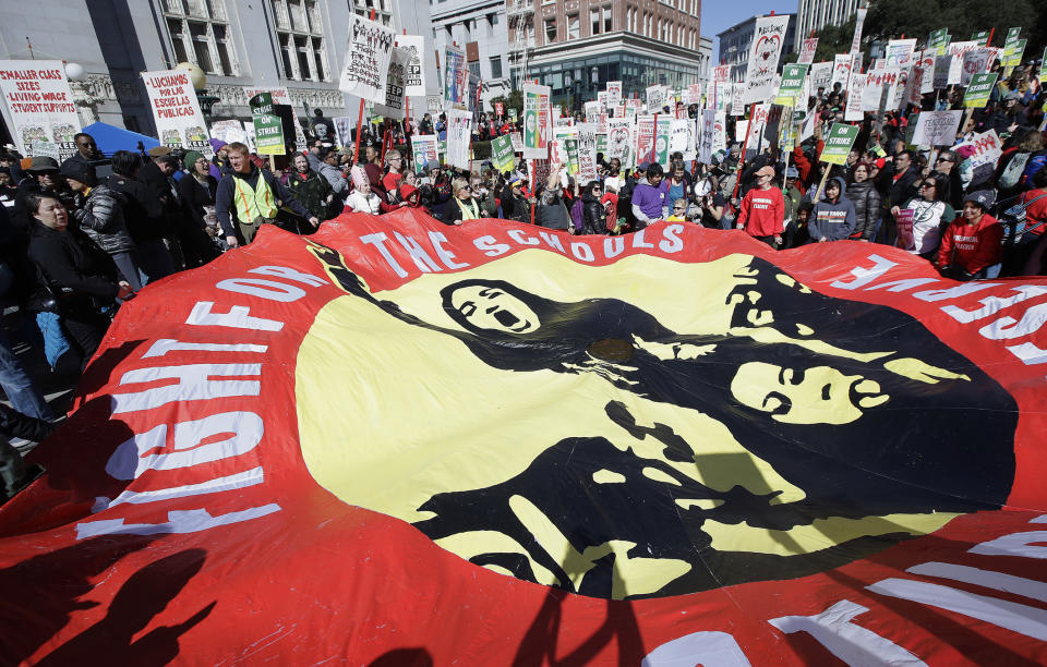 Teachers and supporters at a rally at Frank Ogawa Plaza in front of City Hall in Oakland, Calif., Thursday, Feb. 21, 2019. Teachers in Oakland, California, went on strike Thursday in the country's latest walkout by educators over classroom conditions and pay. (AP Photo/Jeff Chiu)