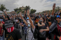 Pro-democracy protesters flash three-finger salutes as they gather for a street march and a rally at Democracy Monument in Bangkok, Thailand, Sunday, Nov. 8, 2020. The protesters continue to gather Sunday, led by their three main demands of Prime Minister Prayuth Chan-ocha's resignation, changes to a constitution that was drafted under military rule and reforms to the constitutional monarchy. (AP Photo/Sakchai Lalit)