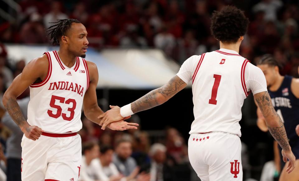 Indiana Hoosiers guard Tamar Bates (53) and Indiana Hoosiers guard Jalen Hood-Schifino (1) high-five during the Big Ten Men’s Basketball Tournament semifinal game against the Penn State Nittany Lions, Saturday, March 11, 2023, at United Center in Chicago. Penn State Nittany Lions won 77-73.