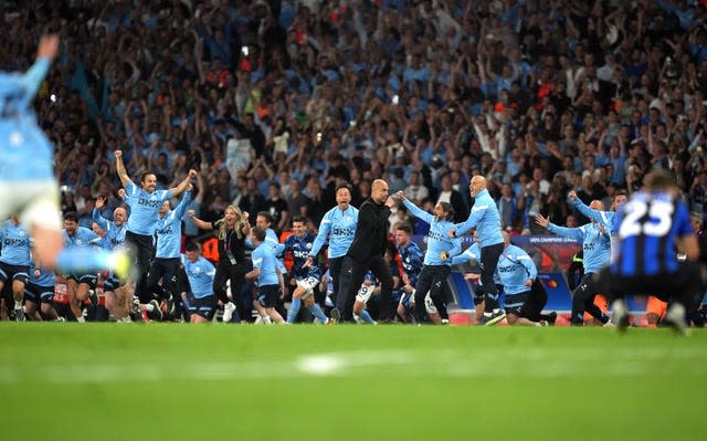 Manchester City's coaching staff celebrate at full-time