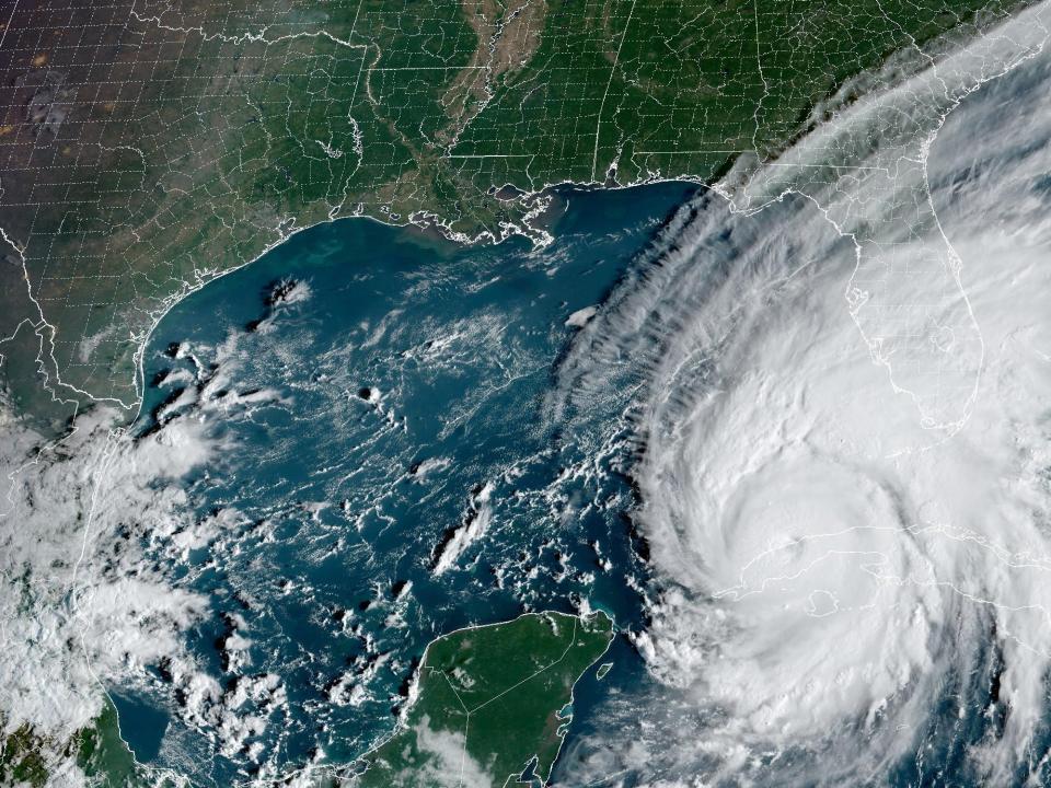 satellite image shows large hurricane ian over cuba with tail clouds covering florida