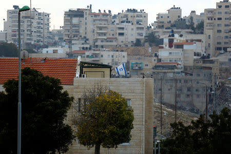 A building can be seen in the Israeli settlement of Maale Edumim, in the occupied West Bank, in the background the Palestinian village of Azariya is seen on the edge of Jerusalem, December 24, 2016. REUTERS/Amir Cohen