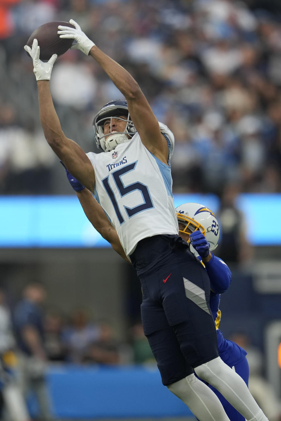 Tennessee Titans wide receiver Nick Westbrook-Ikhine (15) cannot catch a pass in front of Los Angeles Chargers cornerback Bryce Callahan during the first half of an NFL football game in Inglewood, Calif., Sunday, Dec. 18, 2022. (AP Photo/Marcio Jose Sanchez)