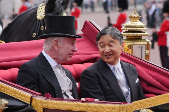 Charles and Emperor Naruhito chat as they travel in a carriage to Buckingham Palace 