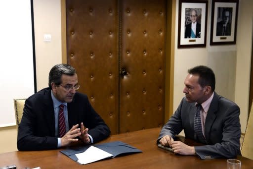 Greek Prime Minister Antonis Samaras (left) and Finance Minister Yannis Stournaras hold a meeting at the Finance Ministry in Athens on August 8. Greece's finance minister said Wednesday the outline of a 11.5 bn euro savings package needed to unlock EU-IMF bailout loans has been agreed, but coalition parties said cuts remain to be decided