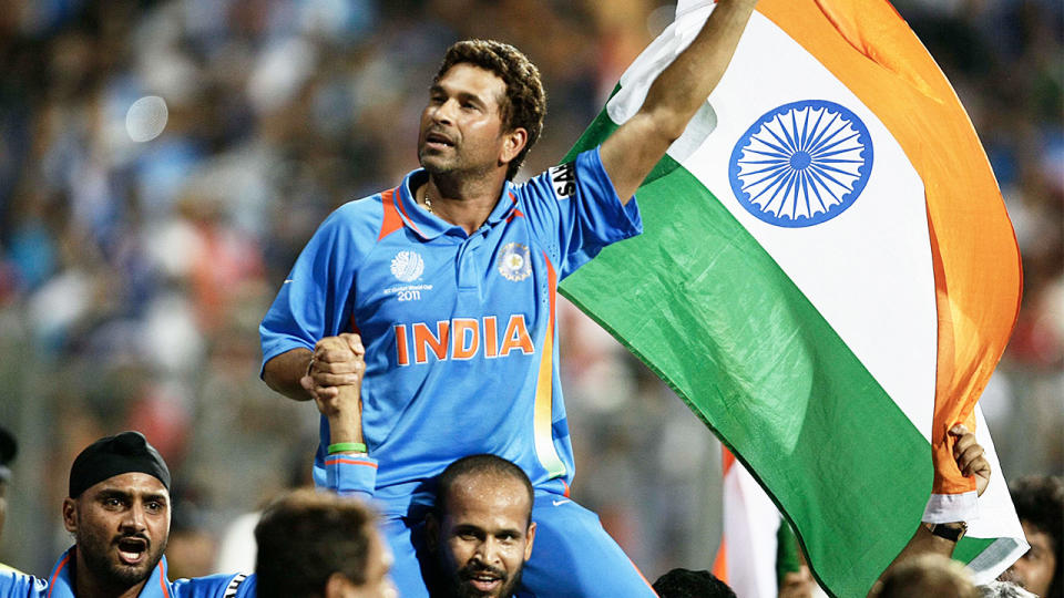 Sachin Tendulkar waves the Indian flag celebrating their team's victory during the ICC Cricket World Cup final match between India and Sri Lanka at The Wankhede Stadium in Mumbai on April 2, 2011. (Getty Images)