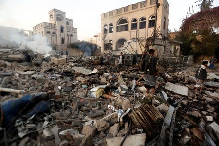 Guards walk on the wreckage of a building destroyed by air strikes in Sanaa, Yemen June 6, 2018. REUTERS/Khaled Abdullah