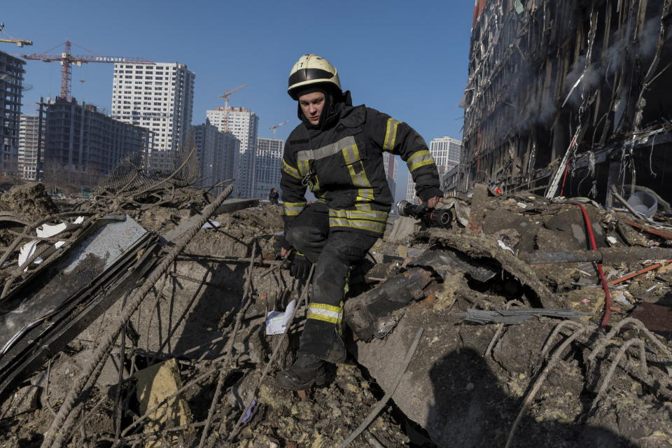 Firefighters work at the site of a bombing at a shopping center as Russia's invasion of Ukraine continues, in Kyiv, Ukraine March 21, 2022. REUTERS/Marko Djurica