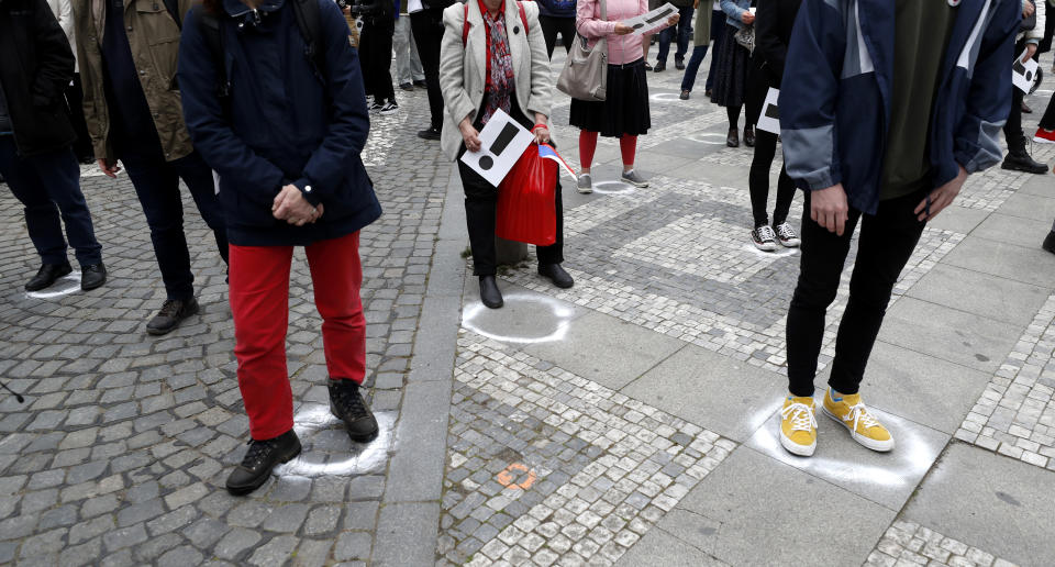 People try to maintain social distance as they gather for a demonstration in Prague, Czech Republic, Thursday, April 29, 2021. Thousands of Czechs have rallied in the capital against President Milos Zeman, accusing him of treason for his pro-Russian stance over the alleged participance of Russian spies in a Czech huge ammunition explosion. (AP Photo/Petr David Josek)