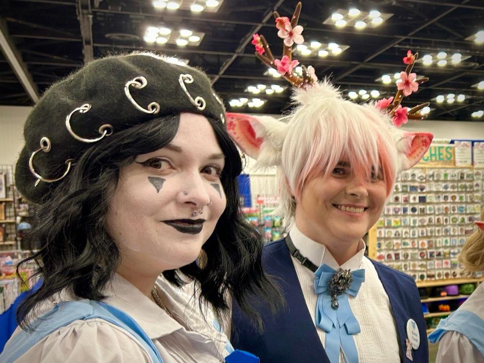 Two members of Ai No Hoshi Maid Cafe smile at PopCon Indy on Friday, April 26 at the Indiana Convention Center. (John Tufts/IndyStar)