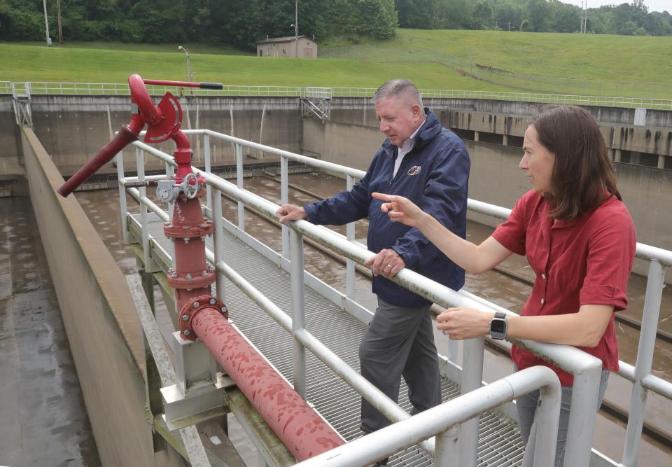 Chris Ludle, director of public service, and Emily Collins, a strategic adviser to Mayor Dan Horrigan, talk about the remaining work to be done on the Akron sewer project while standing at the Cuyahoga Street Storage Facility on Wednesday.