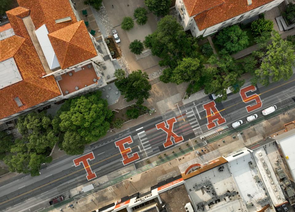 Forty-foot-tall burnt orange letters spelling out TEXAS are painted on Guadalupe Street, also known as the Drag, on May 30 in advance of Sunday's SEC Celebration events marking the school's move from the Big 12 to the Southeastern Conference.