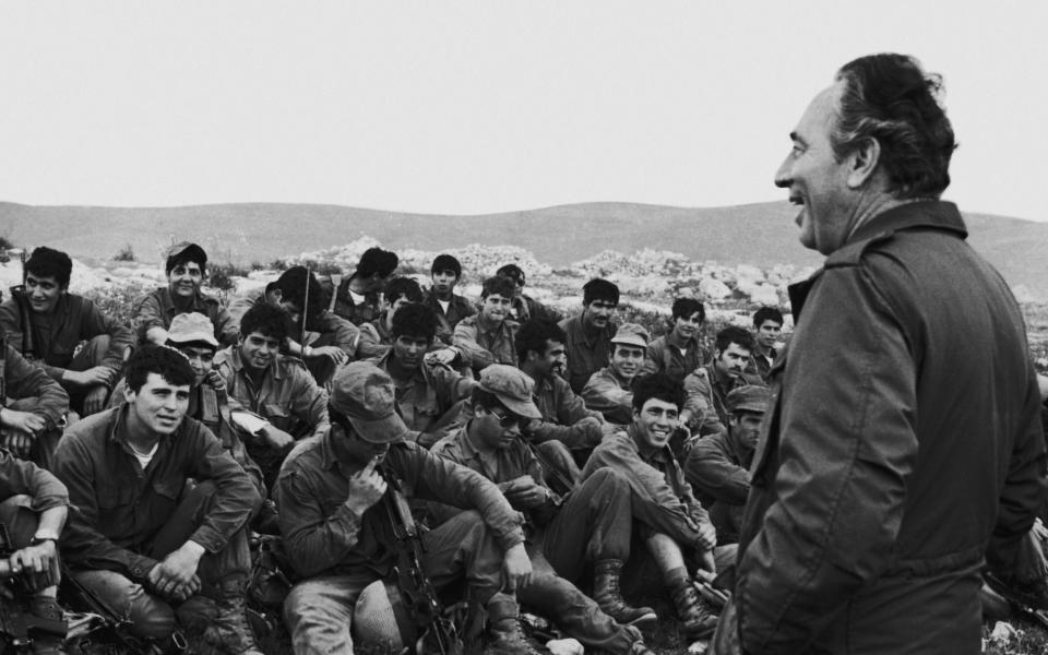 The then Israeli defence minister Shimon Peres (right) addresses Israeli paratroops after the completion of Operation Entebbe