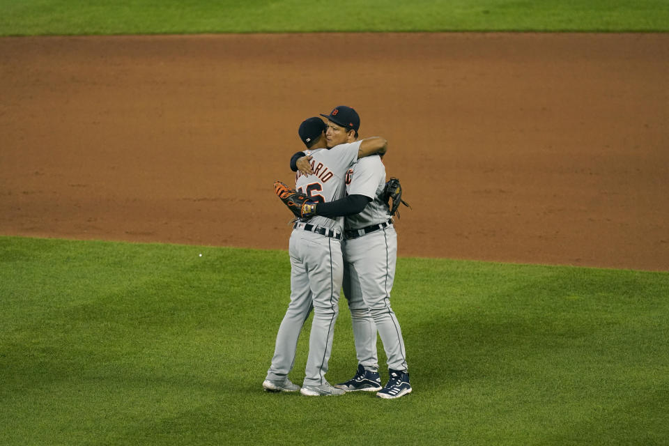Detroit Tigers' Miguel Cabrera, right, and Jeimer Candelario hug after their baseball game against the Kansas City Royals Friday, May 21, 2021, in Kansas City, Mo. The Tigers won 7-5. (AP Photo/Charlie Riedel)