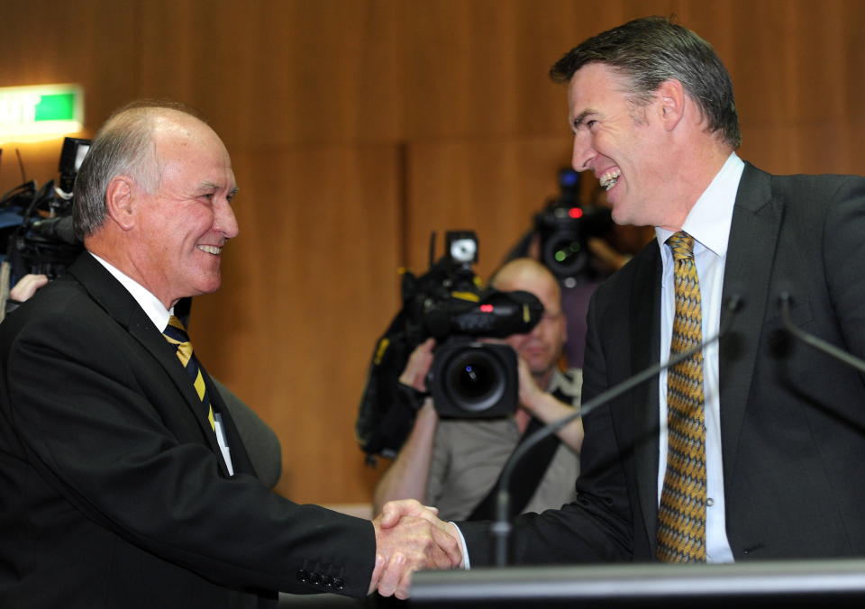 Independents Tony Windsor and Rob Oakeshott shake hands.