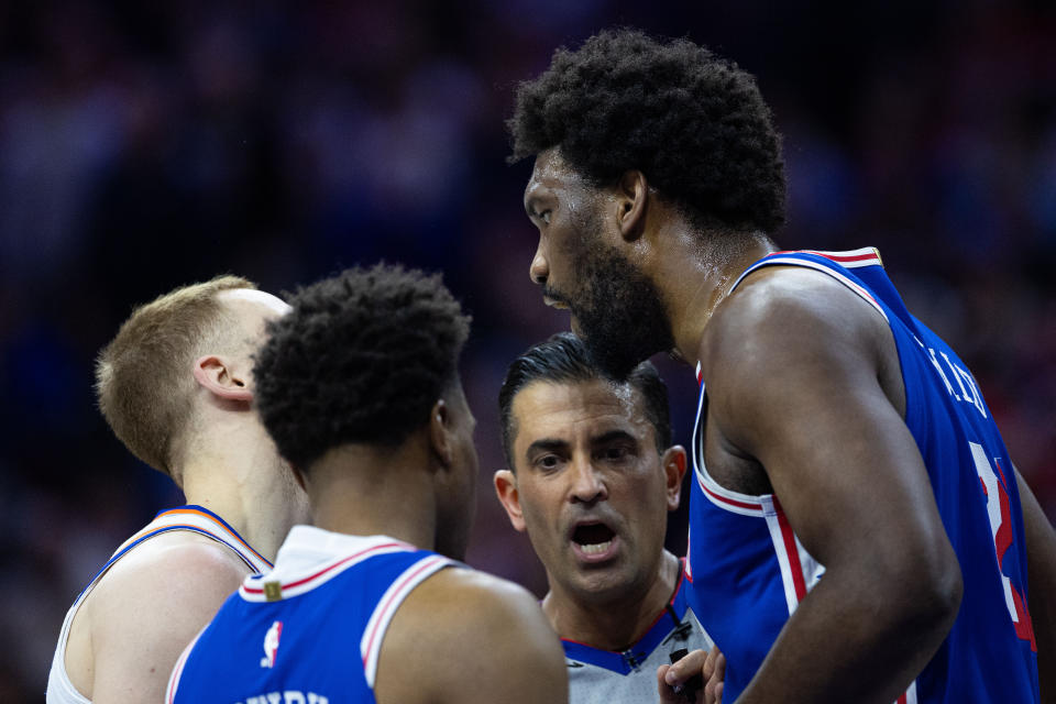 Apr 25, 2024; Philadelphia, Pennsylvania, USA; Philadelphia 76ers center Joel Embiid (21) has words with New York Knicks guard Donte DiVincenzo (L) after a play during the first quarter of game three of the first round for the 2024 NBA playoffs at Wells Fargo Center. Mandatory Credit: Bill Streicher-USA TODAY Sports