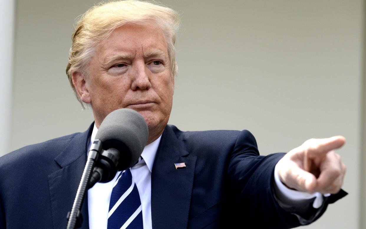 President Donald Trump, taking questions, points to a reporter in the Rose Garden of the White House, after a working lunch with Sen. Majority Leader Mitch McConnell of Kentucky (L), October 16, 2017, in Washington, DC - Barcroft Media