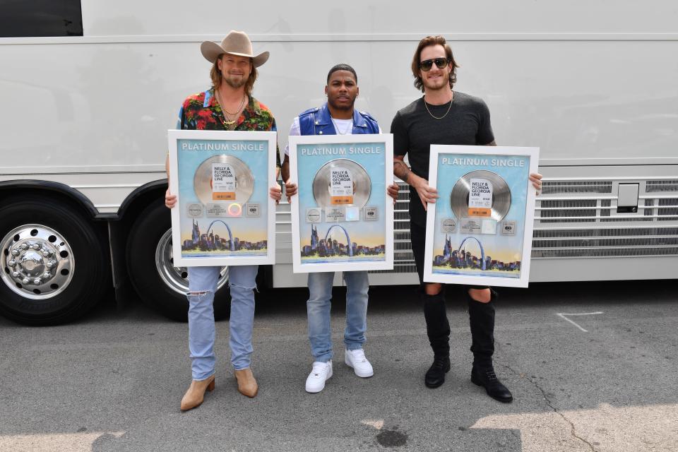 FRANKLIN, TENNESSEE - SEPTEMBER 01: Brian Kelley and Tyler Hubbard of Florida Georgia Line and Nelly (C) take photos with their Platinum Single for "lil bit" during CMT Crossroads: Nelly & friends at The Factory At Franklin on September 01, 2021 in Franklin, Tennessee. (Photo by Jason Davis/Getty Images for CMT)