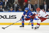 New York Rangers left wing Artemi Panarin (10) and Carolina Hurricanes defenseman Brady Skjei (76) fight for the puck during the third period in Game 1 of an NHL hockey Stanley Cup second-round playoff series, Sunday, May 5, 2024, in New York. (AP Photo/Julia Nikhinson)