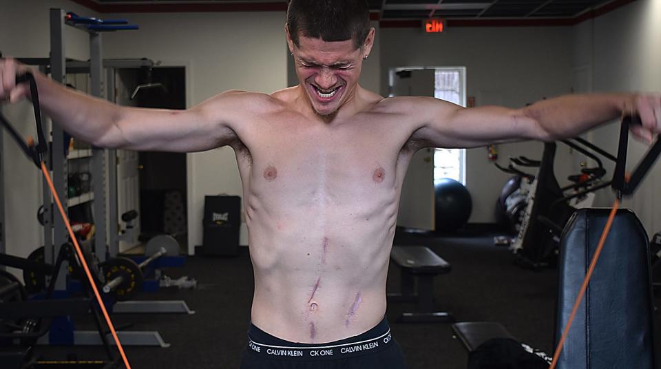 Corey Andrade works out at ABM Fitness in Fall River in 2022. He was the victim of a brutal stabbing in 2021 that left him with almost two dozen stab wounds and near death.