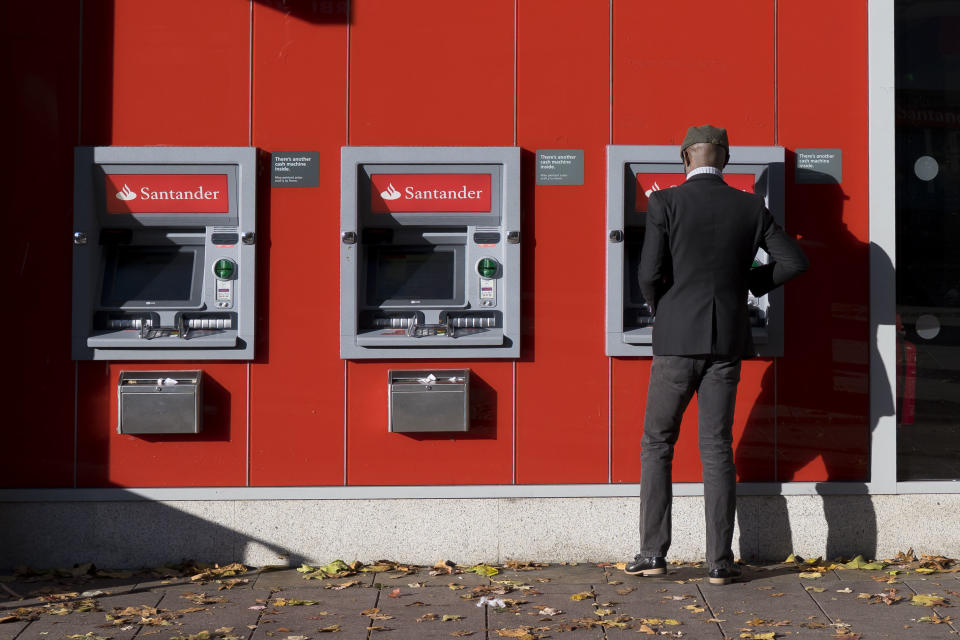 CARDIFF, UNITED KINGDOM - OCTOBER 28: A man uses a Santander cashpoint on October 28, 2018 in Cardiff, United Kingdom. (Photo by Matthew Horwood/Getty Images)