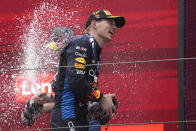 Red Bull driver Max Verstappen of the Netherlands celebrates on the podium after winning the Chinese Formula One Grand Prix at the Shanghai International Circuit, Shanghai, China, Sunday, April 21, 2024. (AP Photo/Andy Wong)