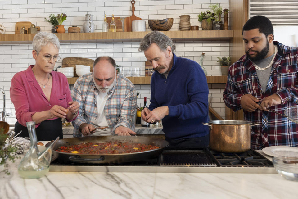 This image released by Prime Video shows actor Jamie Lee Curtis, from left, chef José Andrés, and actors Bryan Cranston and O'Shea Jackson Jr., in a scene from the special "Dinner Party Diaries with Jose Andres," premiering March 19. (Michael Muller/Prime Video via AP)