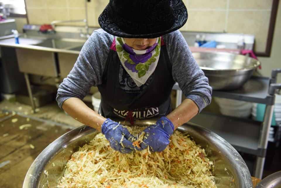 A volunteer with Korean Presbyterian Church mixes ingredients for spring rolls during the annual Spring Roll Bazaar.