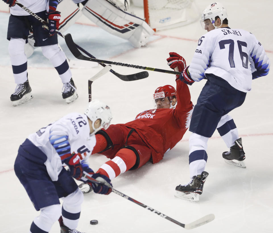 Frank Vatrano of the US, left, and Brady Skjei of the US, right, challenge Denmark's Mathias Bau, center, during the Ice Hockey World Championships group A match between Denmark and the United States at the Steel Arena in Kosice, Slovakia, Saturday, May 18, 2019. (AP Photo/Petr David Josek)