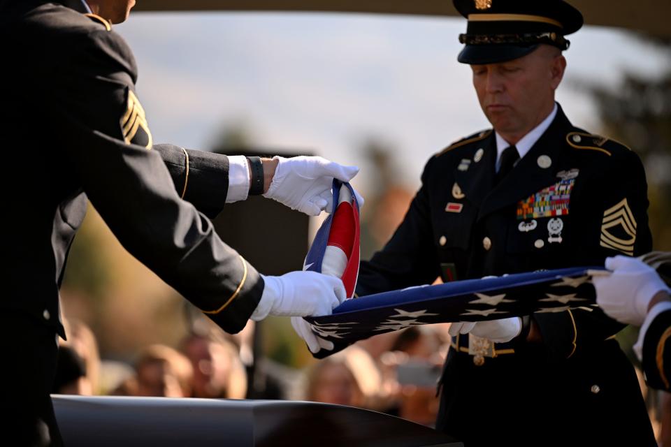 Military members conduct a flag presentation at President M. Russell Ballard’s graveside service in the Salt Lake City Cemetery on Friday, Nov. 17, 2023. | Scott G Winterton, Deseret News