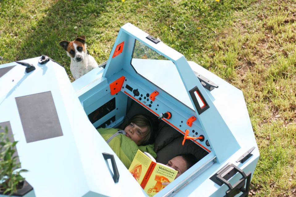 A mother and son enjoy a beautiful summer day from inside the comfort of the Z-Triton's camper pod. 