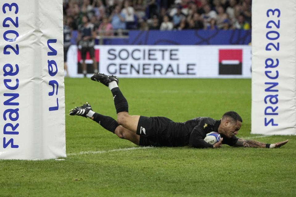 New Zealand's Aaron Smith scores a try during the Rugby World Cup Pool A match between New Zealand and Italy at the OL Stadium in Lyon, France, Friday, Sept. 29, 2023. (AP Photo/Laurent Cipriani)