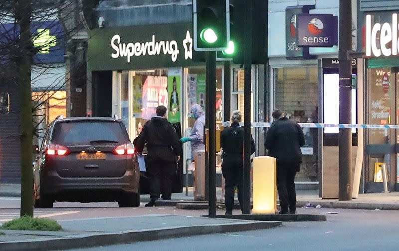 A police forensics officer is seen near a site where a man was shot by armed officers in Streatham, south London