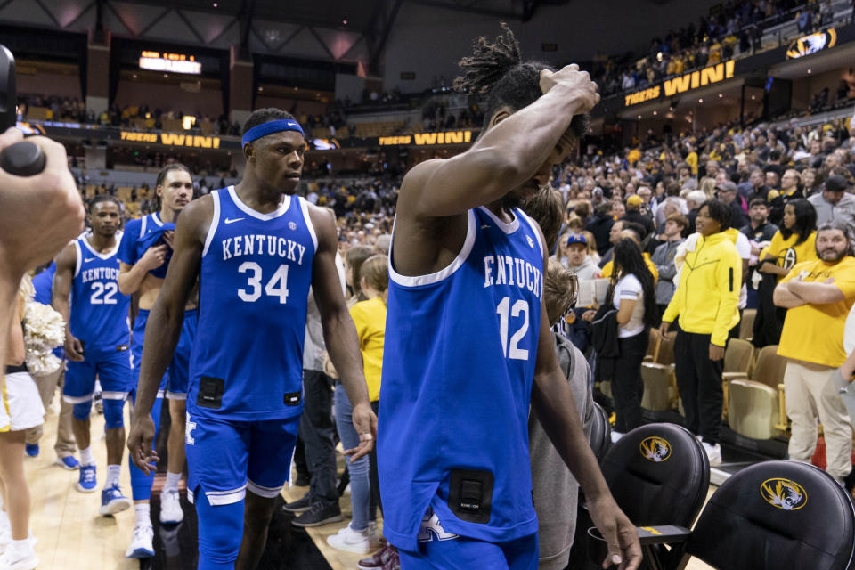 Kentucky's Antonio Reeves, right, and Oscar Tshiebwe (34) walk off the court after their 89-75 loss to Missouri in an NCAA college basketball game Wednesday, Dec. 28, 2022, in Columbia, Mo. (AP Photo/L.G. Patterson)