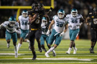 Appalachian State running back Camerun Peoples (6) breaks a tackle and runs for a touchdown during the second half of the team's NCAA college football game against Coastal Carolina on Wednesday, Oct. 20, 2021, in Boone, N.C. (AP Photo/Matt Kelley)