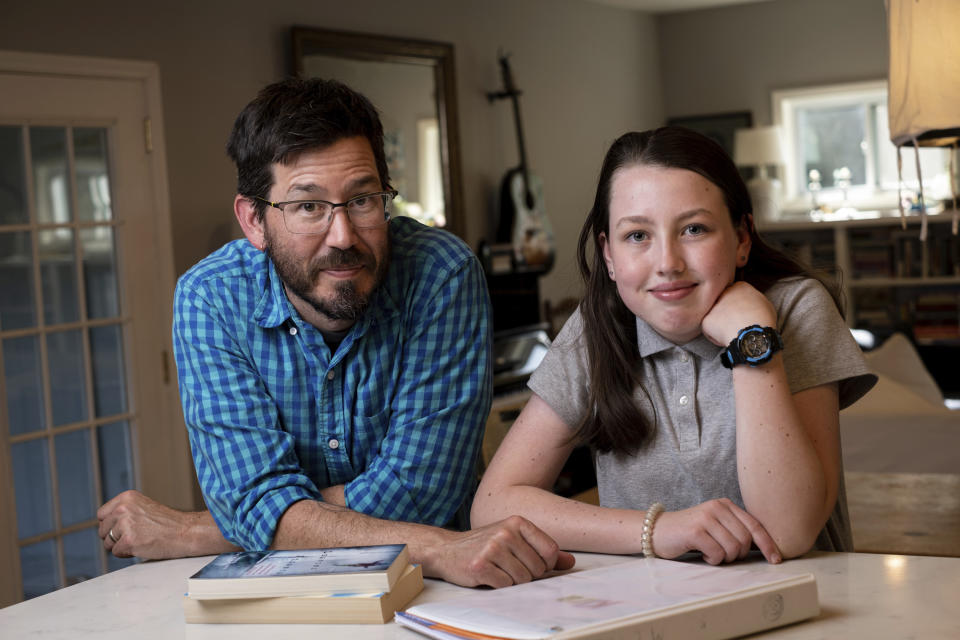 Jay Wamsted, left, and his daughter, Kira, are photographed on Thursday, May 20, 2021 in Smyrna, Ga. Wamsted, who is an 8th grade math teacher, allowed his daughter to skip testing this year. With new flexibility from the Biden administration, states are adopting a patchwork of testing plans that aim to curb the stress of exams while still capturing some data on student learning. (AP Photo/Ben Gray)