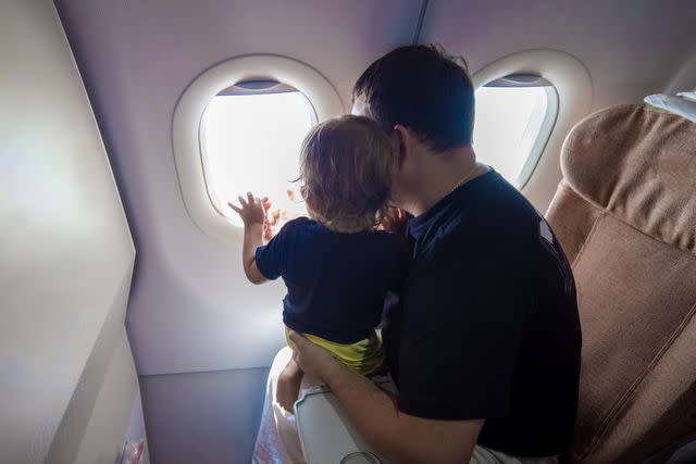 <p>Getty</p> Father with baby on airplane